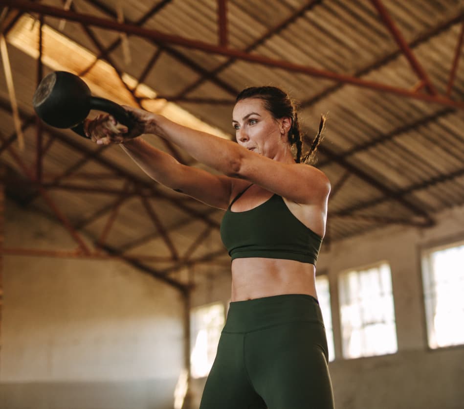 woman-using-kettle-ball