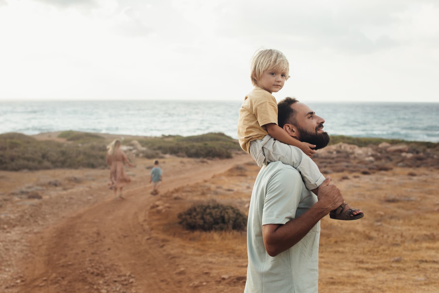 A father and his son are hiking in nature