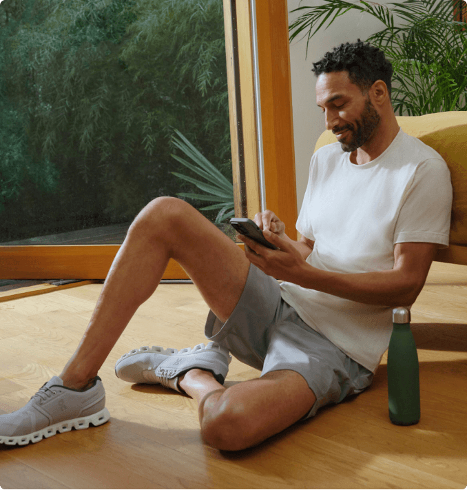 man sitting on floor with phone