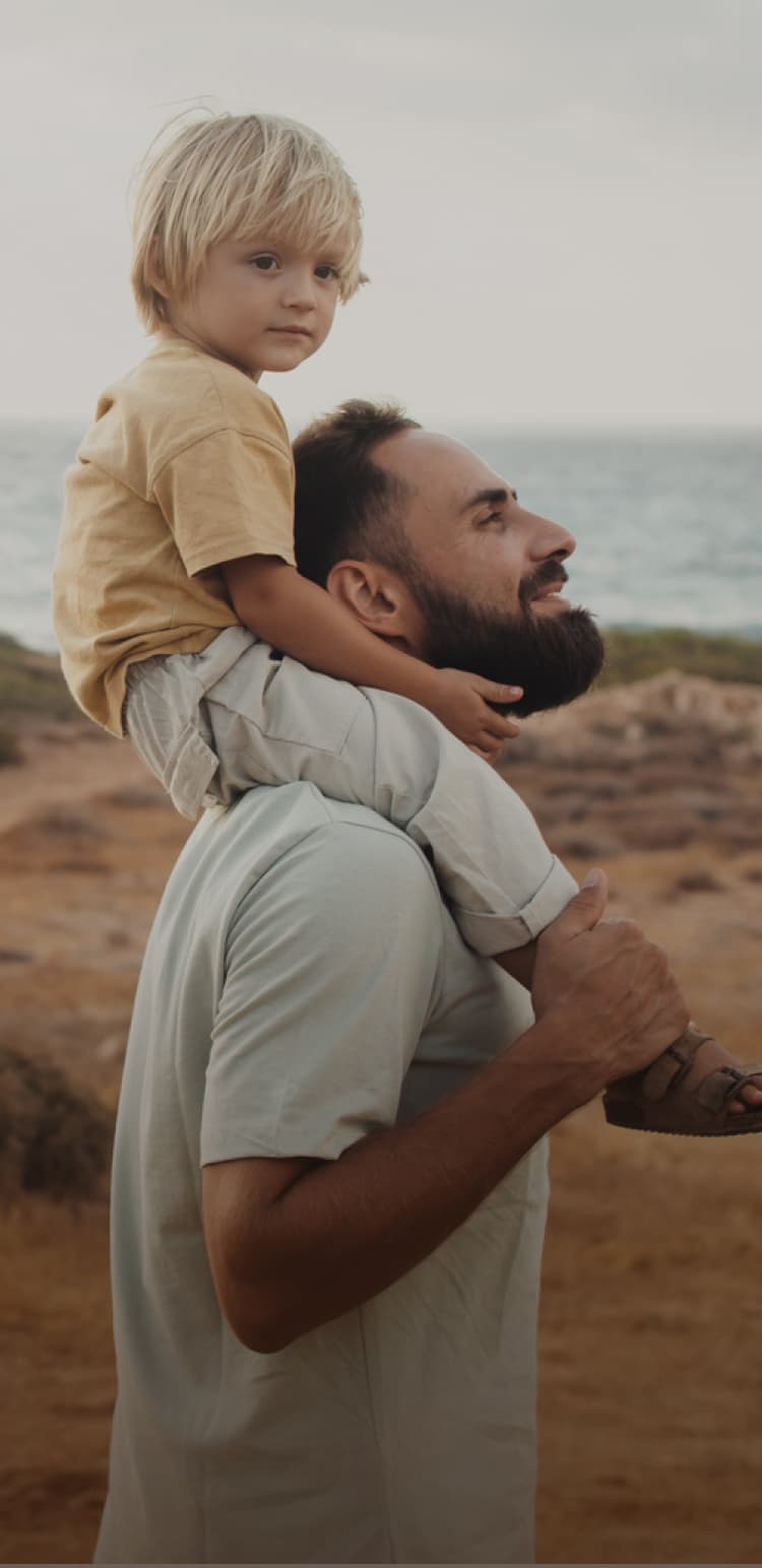 A father and his son are hiking in nature